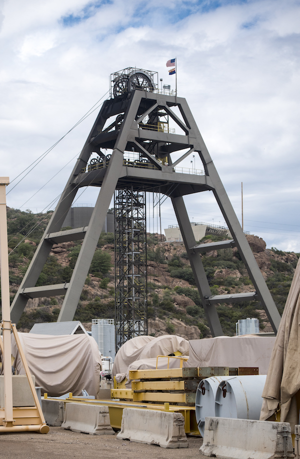 Photo of Magma Copper Mine large metal structure above mining Shaft #10 with industrial mining equipment and material in the foreground